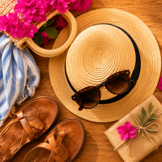 Shopping in Corfu with leather sandals, straw hat, sunglasses, flowers and wrapped souvenirs