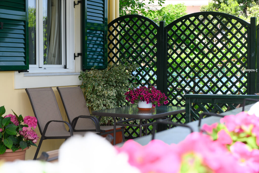 Green veranda with flowers at Nostalgia Corfu Town Apartments